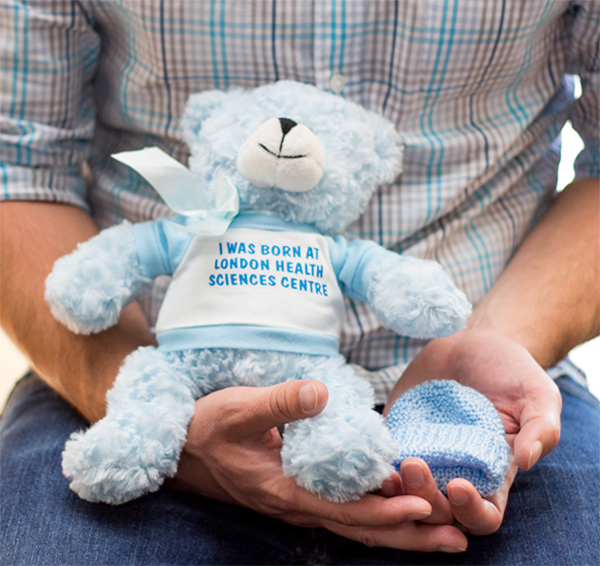 Neil holding Jacob's bear and hat