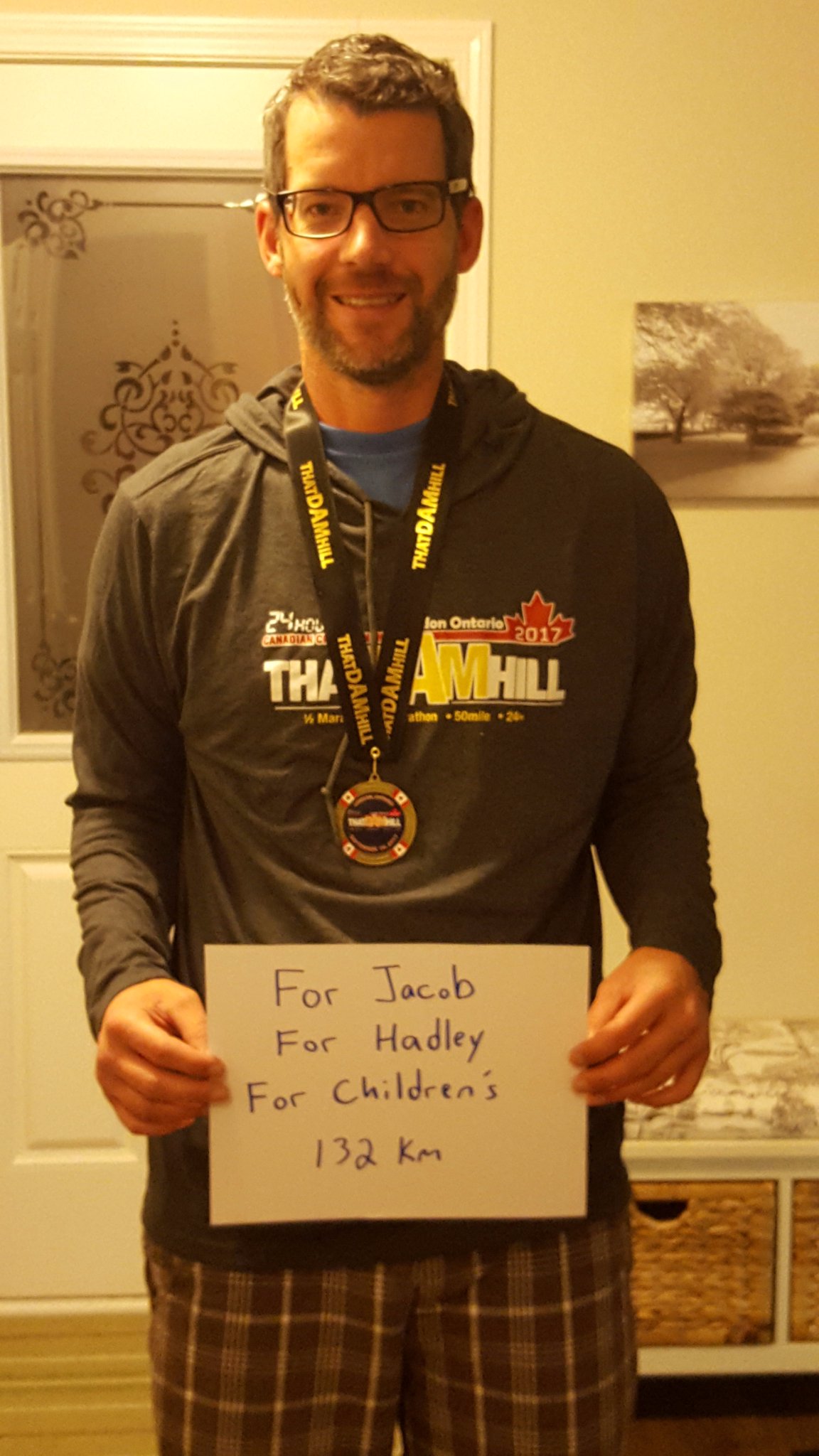 Neil holds a sign for Hadley and Jacob